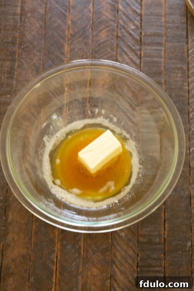 Next-Level Brown Butter Chocolate Chip Cookies 4 More butter added to the warm brown butter in a mixing bowl.