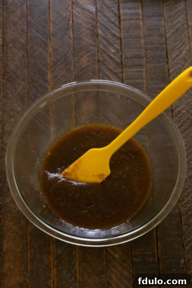 Next-Level Brown Butter Chocolate Chip Cookies 5 Brown butter mixture with granulated sugar, dark brown sugar, whole egg, and egg yolk added.