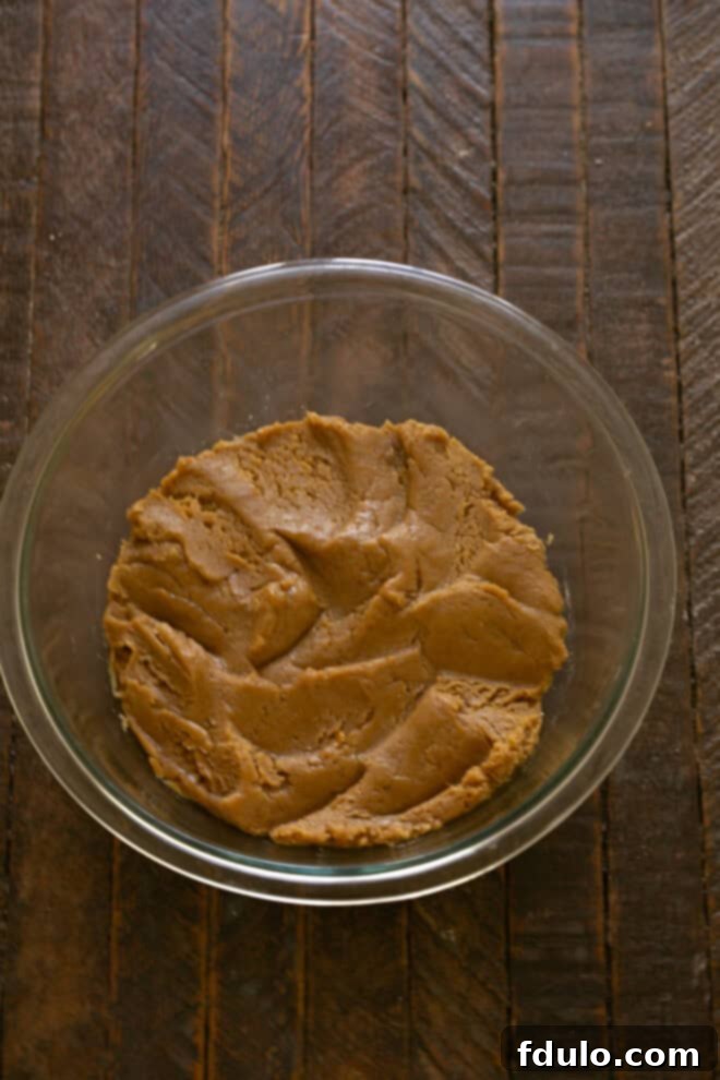 Next-Level Brown Butter Chocolate Chip Cookies 6 Dry ingredients (flour, baking soda, salt) being added to the wet mixture.