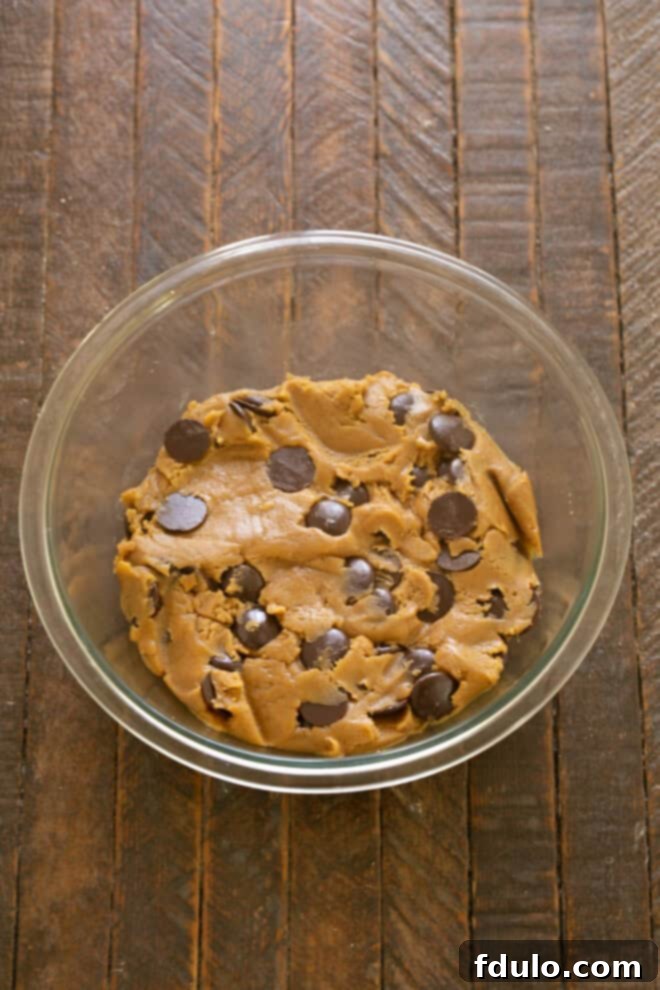 Next-Level Brown Butter Chocolate Chip Cookies 7 Chocolate chips or chunks being folded into the cookie dough.