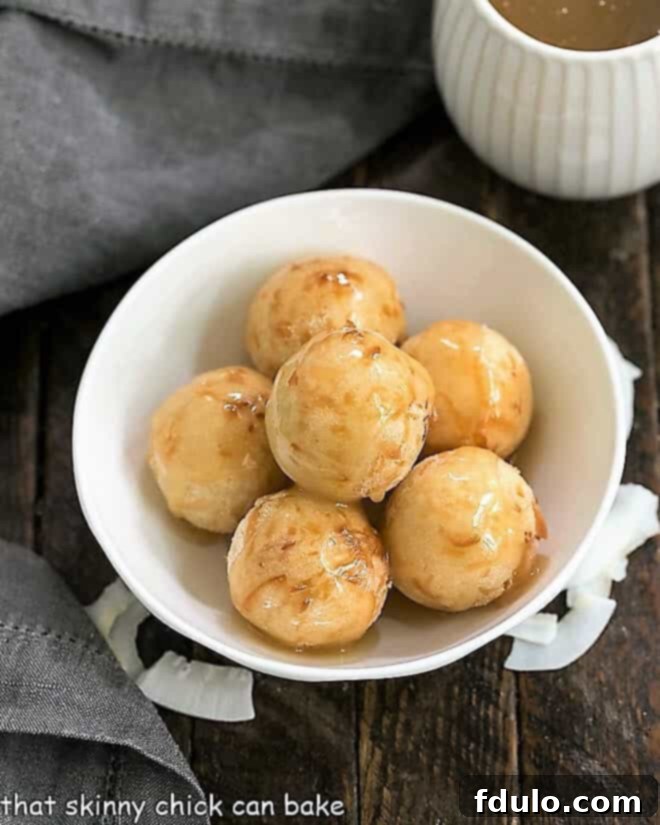 Carioca or Fried Sticky Rice Balls - a Filipino treat with a triple dose of coconut including the drizzle of decadent coconut caramel sauce! Fried Sticky Rice Balls, or Carioca, arranged beautifully in a white serving bowl, showcasing their golden-brown exterior and inviting texture, ready to be enjoyed as a sweet Filipino snack or dessert.