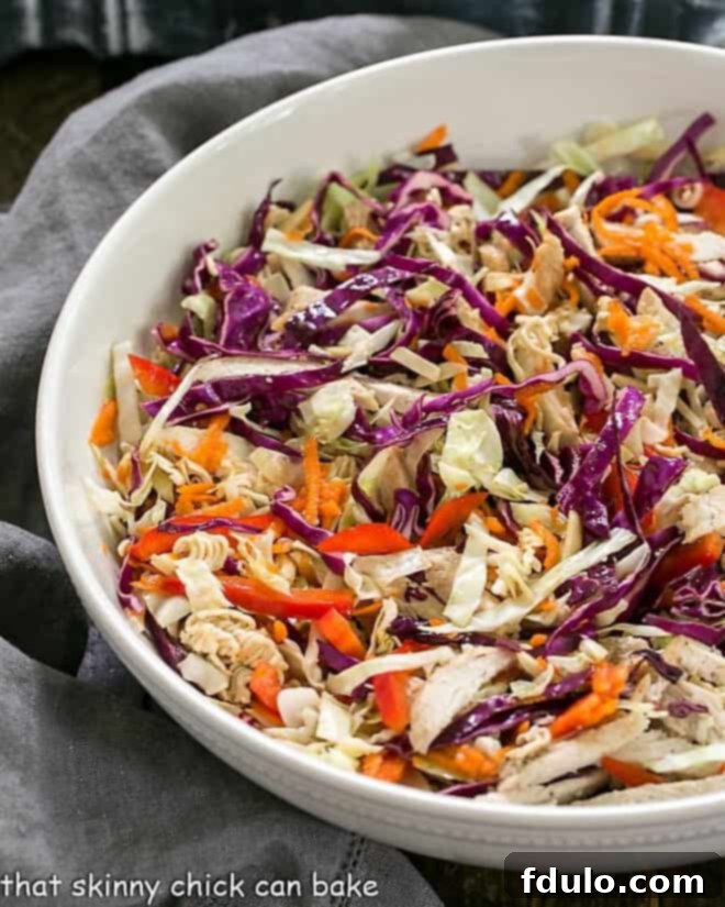 Asian Ramen Noodle Salad with Chicken in a white ceramic serving bowl.