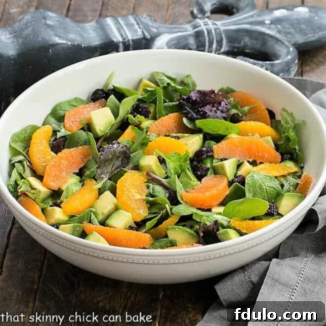 Cherry Orange Salad with Citrus Vinaigrette in a white ceramic serving bowl, garnished and ready to be enjoyed.