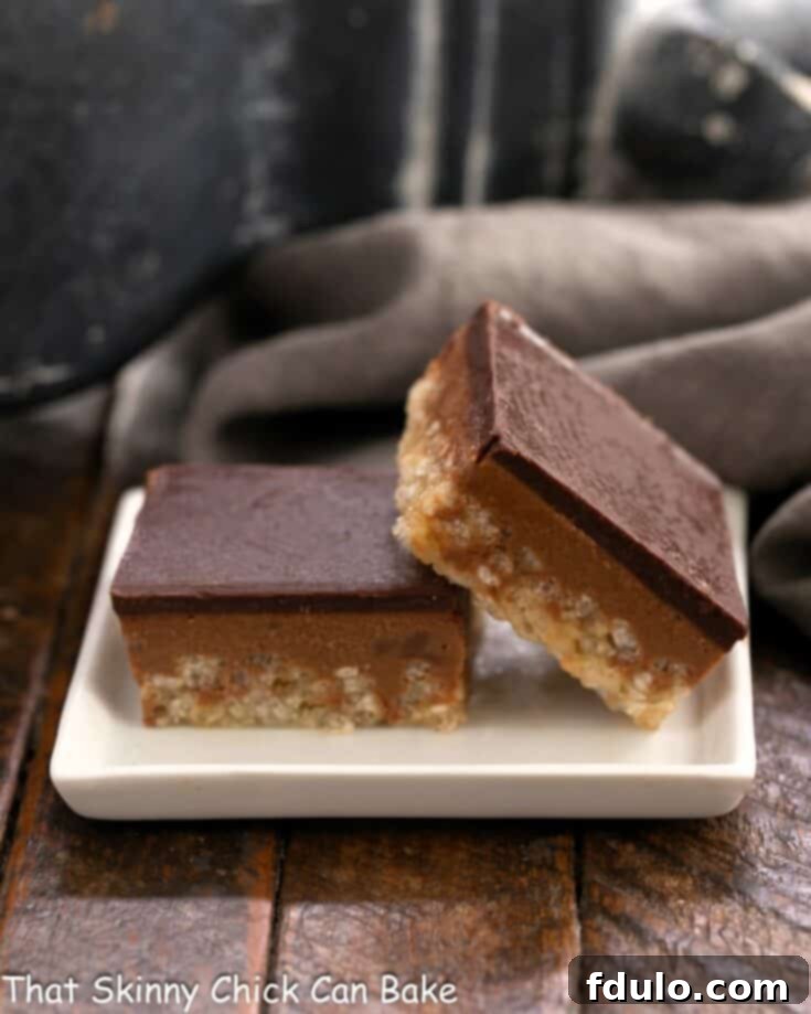 Peanut Butter Chocolate Krispie Dream Bars 10 Two scotcheroos on a small white ceramic plate.