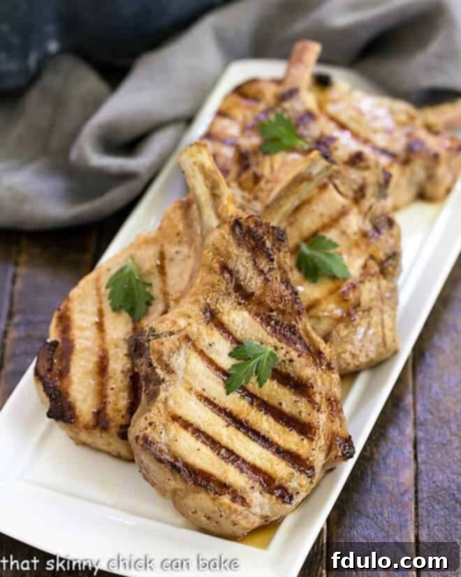 Platter of grilled marinated pork chops, beautifully seared and ready to be served.