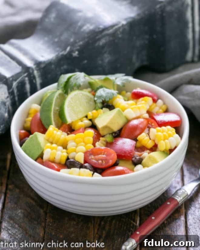 A small serving bowl filled with vibrant Avocado Corn Salad, ready to be enjoyed.