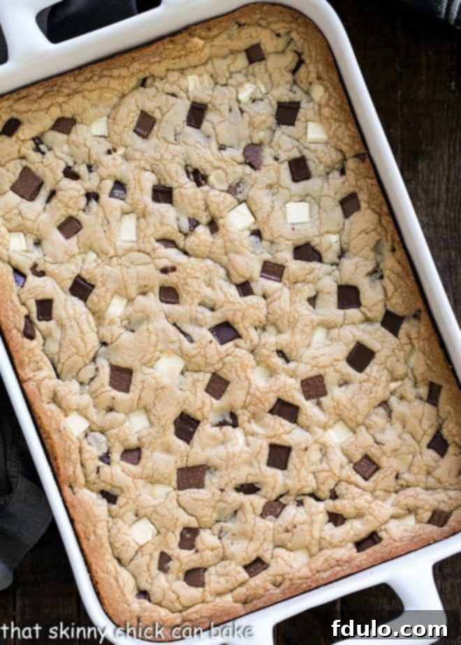 Overhead view of white ceramic 9 x 13-inch baking pan filled with chocolate chunk cookies