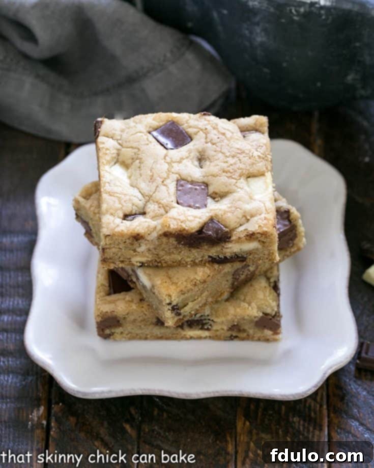 3 chocolate chunk bars stacked on a square white plate