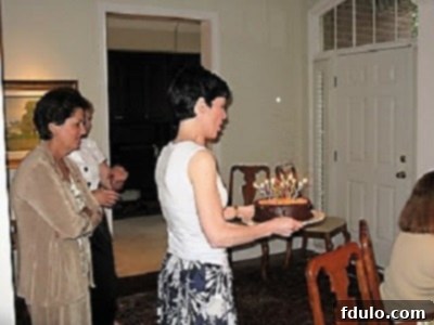 Liz joyfully carrying a German Chocolate Cake in 2009, capturing a cherished moment of celebration.