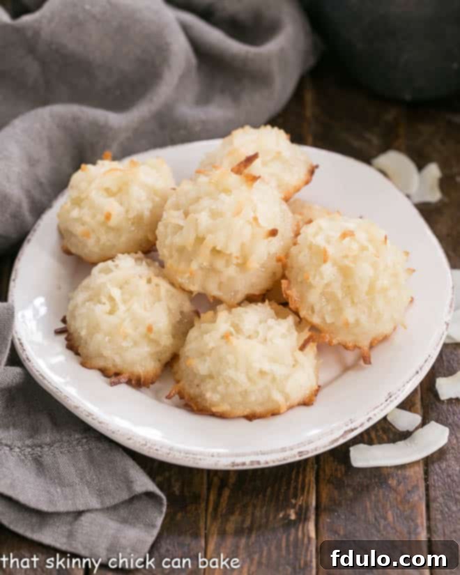 Close-up of golden Classic Coconut Macaroons on a round white plate.