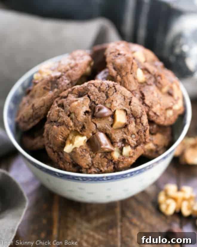 Chocolate Toffee Cookies in a white and blue bowl.