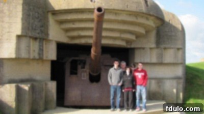 A family gathered on Omaha Beach in Normandy, France, overlooking the historic shores.