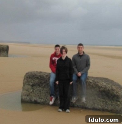 Children playing on the vast, sandy expanse of Normandy Beach in France, a picturesque and historic setting.