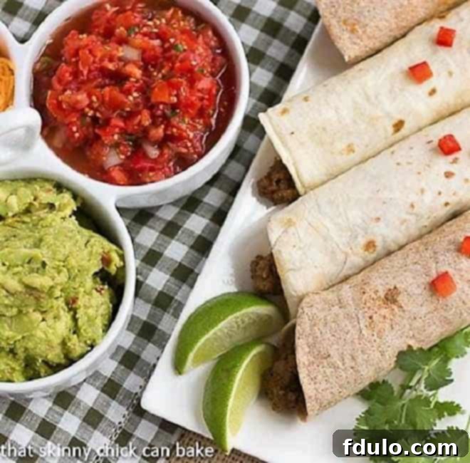 Overhead view of Soft Shell Tacos {Homemade Beef Tacos} on a platter next to toppings, showcasing fresh, vibrant ingredients.