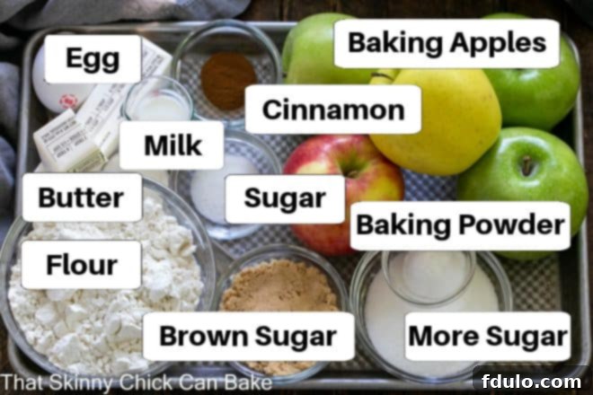 A baking sheet displaying all the labeled ingredients required to make a delicious Apple Kuchen.
