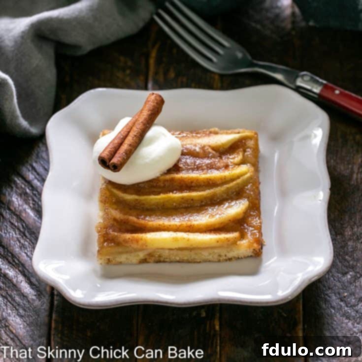 Slice of apple kuchen on a square white dessert plate