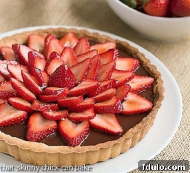 Strawberry Topped Chocolate Tart on a white ceramic plate, ready to be served