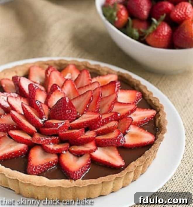 Strawberry Topped Chocolate Tart on a white serving plate