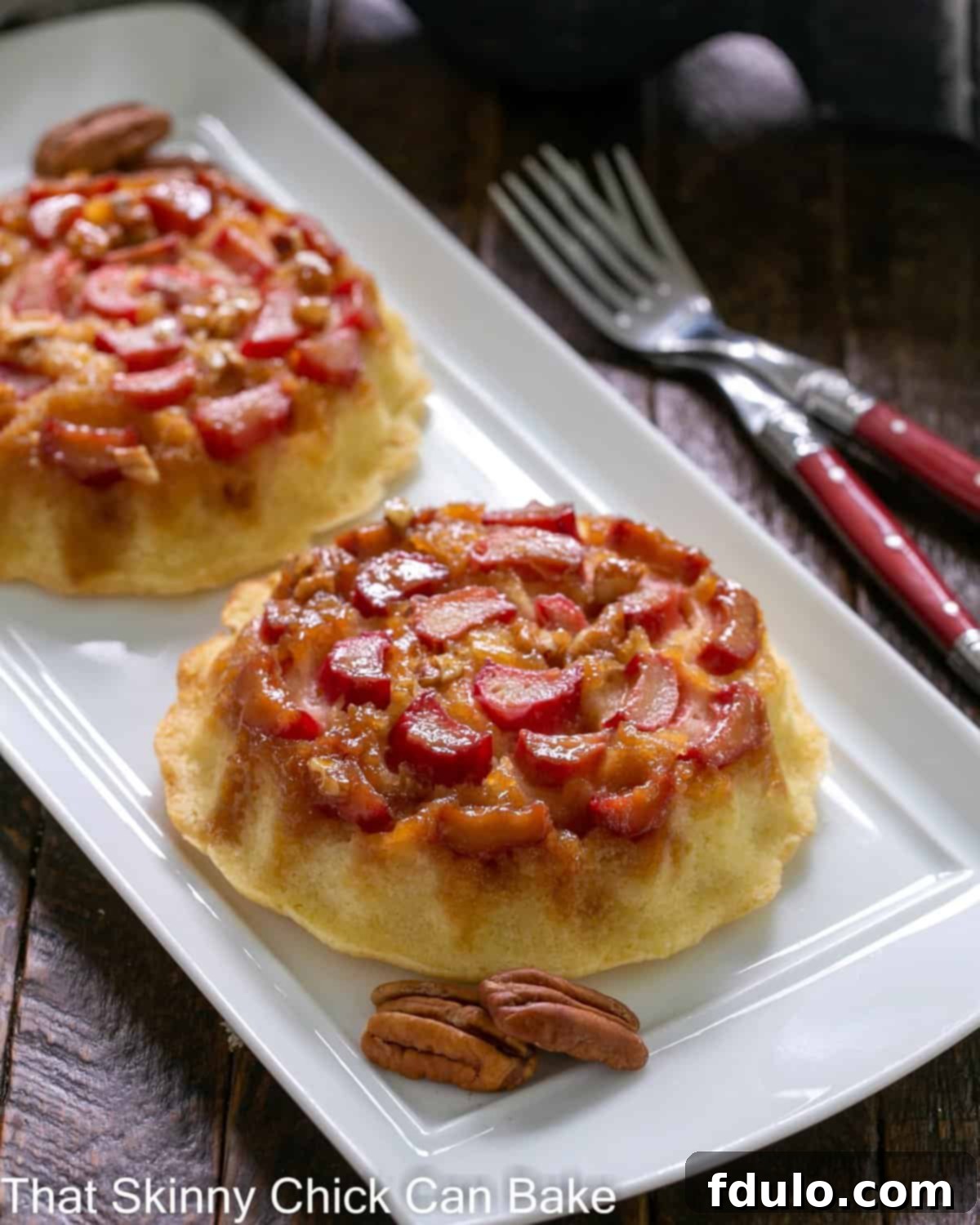 Fresh Rhubarb Upside-down Baby Cakes - a delicious way to enjoy spring rhubarb for dessert! Fresh Rhubarb Upside-down Baby Cakes on a white ceramic tray, showcasing their beautiful caramelized tops.