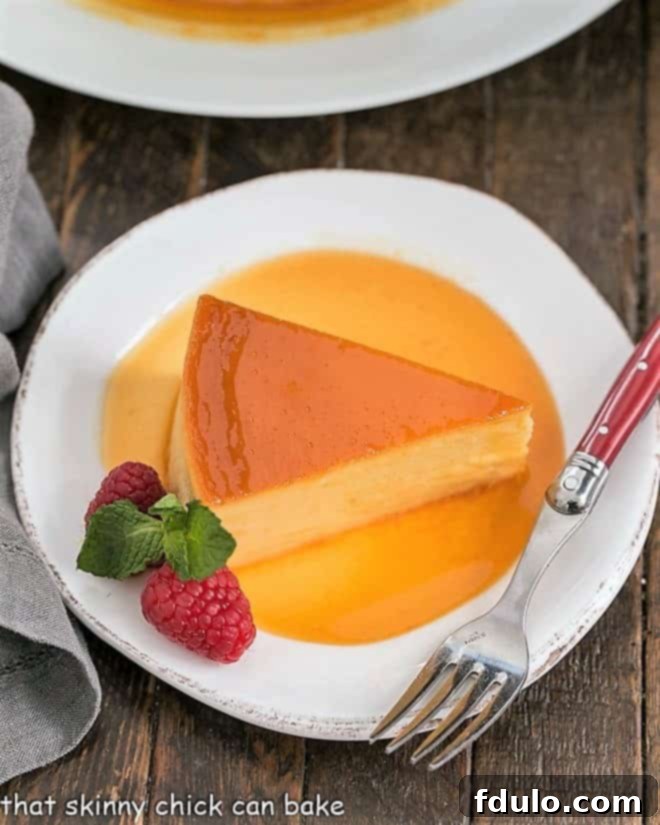 Close-up overhead view of a slice of Cream Cheese Caramel Flan, showcasing the creamy custard and generous caramel sauce.