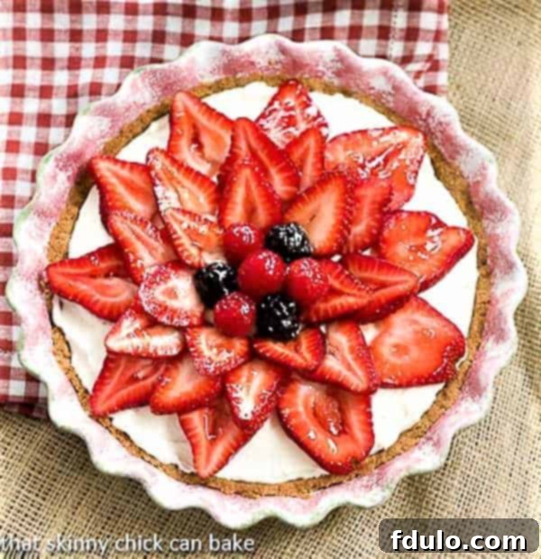 Decadent Strawberry Cream Cheese Dessert in a ceramic pie plate, showcasing fresh berries and creamy filling.