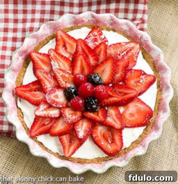 Strawberry Cream Cheese Dessert | A dreamy cream cheese and whipped cream filling topped with juicy ripe strawberries!