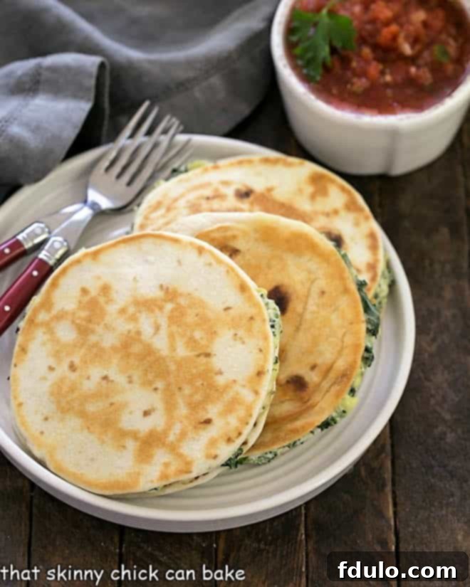 Three perfectly golden-brown spinach dip quesadillas, cut in half, arranged on a crisp white plate with bright red salsa and a sprig of fresh parsley, highlighting their delicious cheesy interior.
