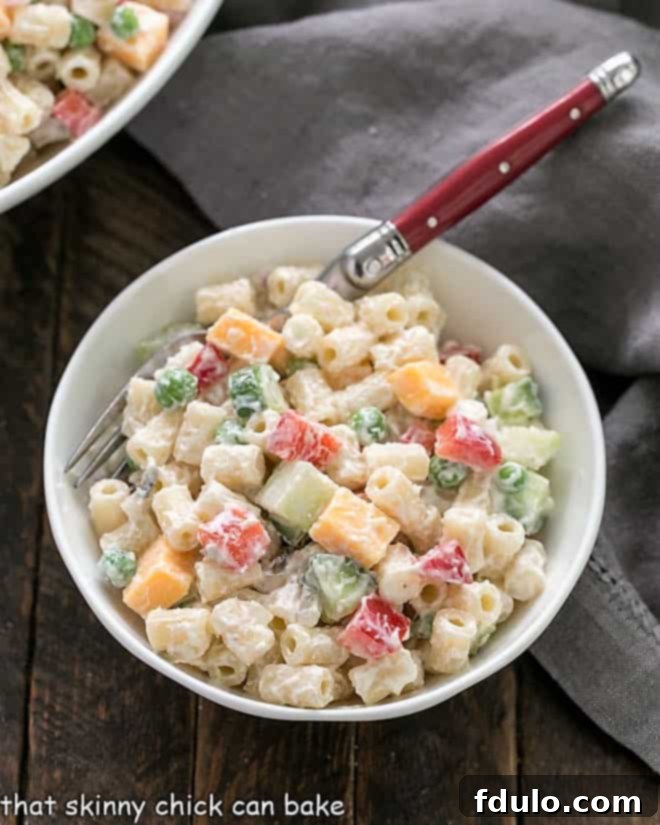 Small bowl of macaroni salad with fresh parsley garnish.