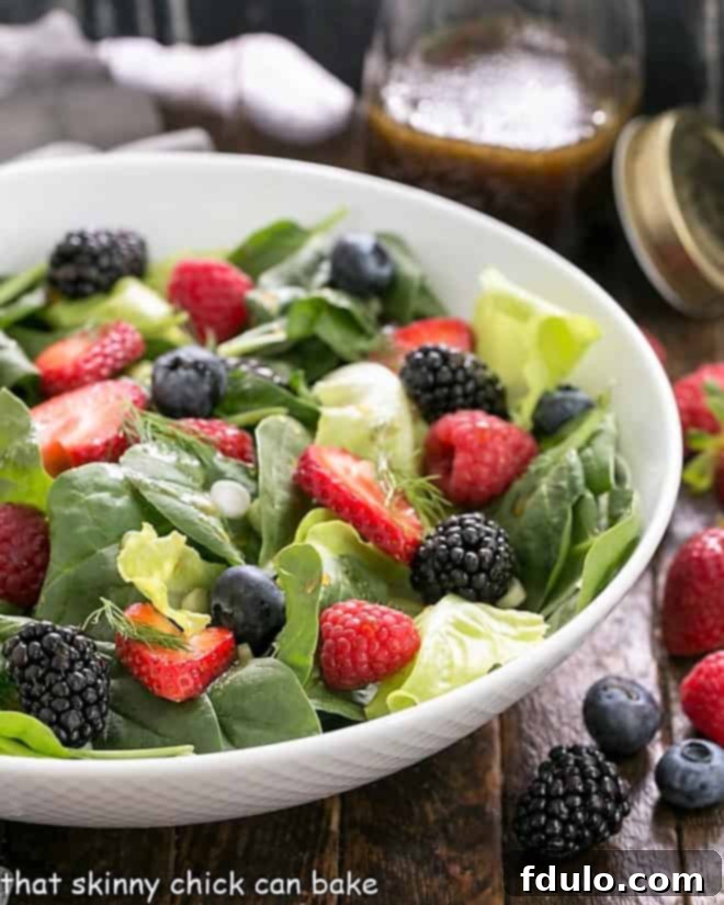 Spinach Almond and Berries Salad in a white serving bowl