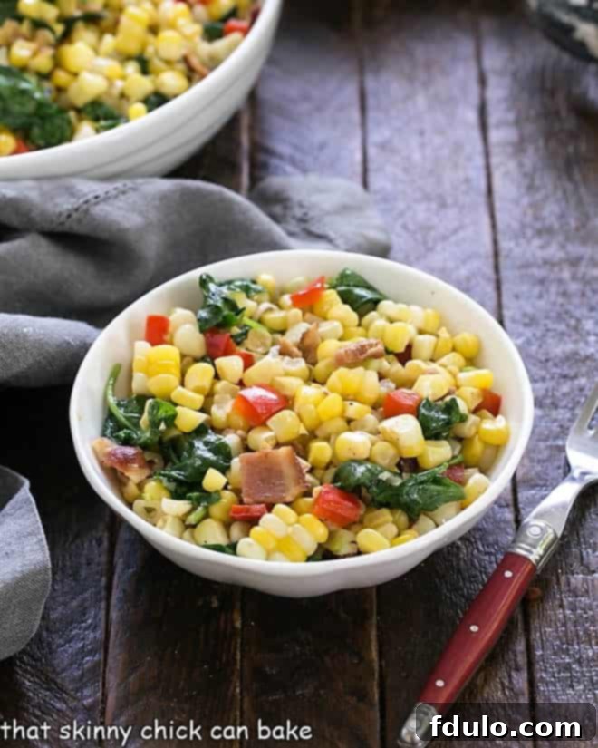 Vibrant Skillet Corn, Spinach, and Peppers 2 Close-up of Skillet Corn with Spinach and Peppers in a small white bowl with a red-handled fork, ready to be enjoyed.