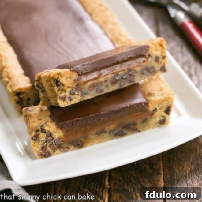 Chocolate chip cookie tart with 2 slices cut, revealing the rich caramel and cookie layers