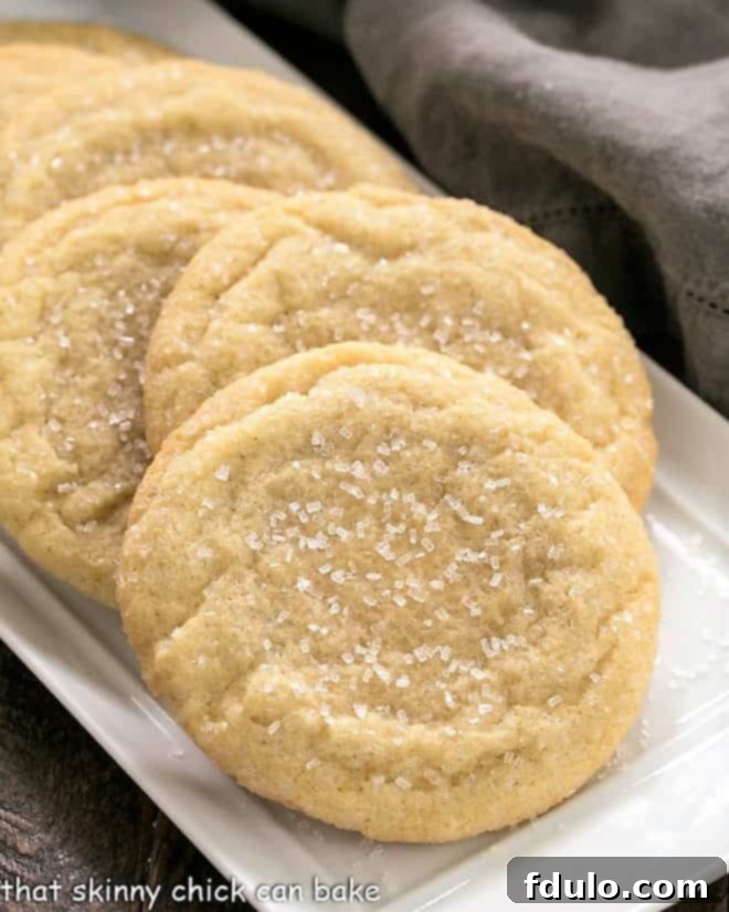 Staggered Giant Sugar Cookies on a white tray, coated with sparkling coarse sugar.