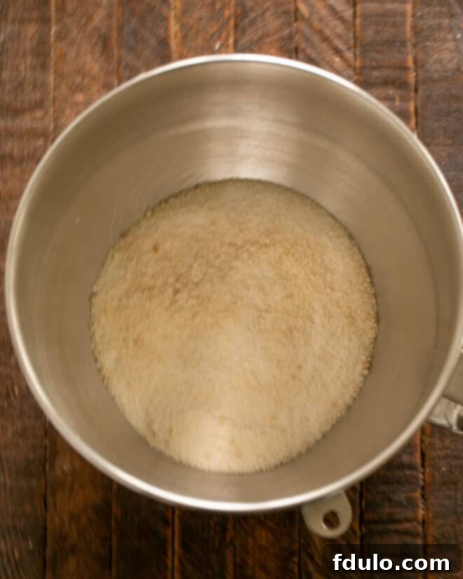 Step 2: Cream together granulated and brown sugars in an electric mixer with a paddle attachment.