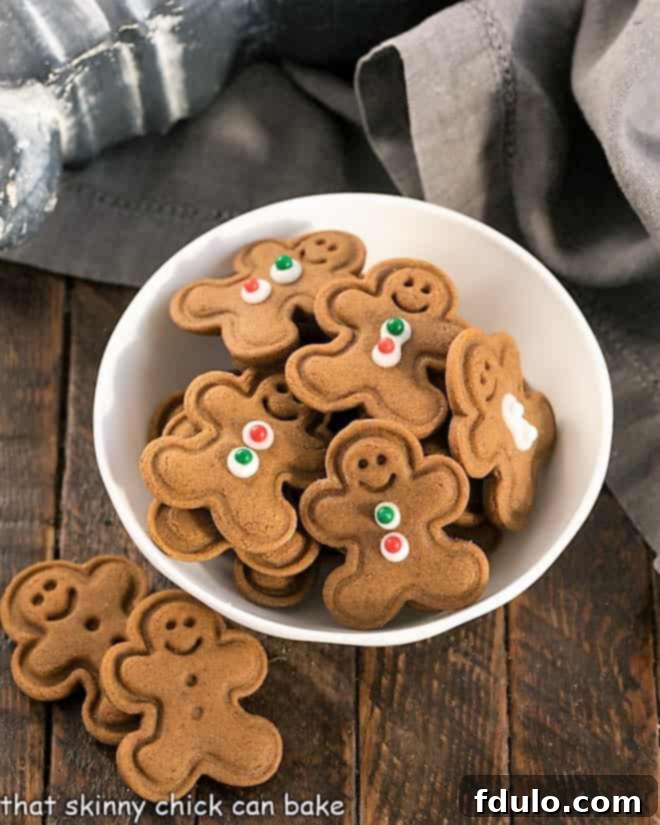 The Ultimate Guide to Gingerbread Perfection 3 A small white bowl brimming with adorable mini gingerbread men cookies, each one ready to bring a smile.