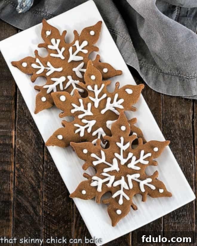 The Ultimate Guide to Gingerbread Perfection 4 An overhead view showcasing three intricately designed gingerbread snowflakes, highlighting their delicate patterns and festive appeal.