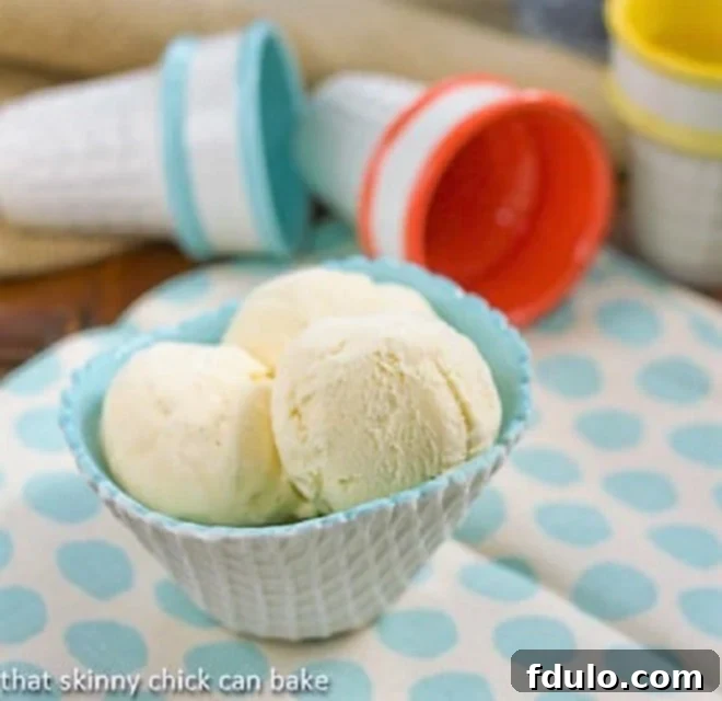 Vanilla Bean Ice Cream in a white and turquoise ice cream bowl on a polka dot napkin
