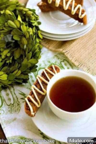 A charming stack of Gingerbread Biscotti served with a steaming mug, highlighting their inviting appeal.
