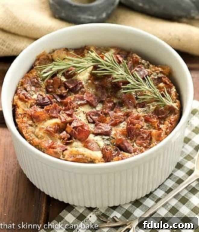Prosciutto, Gorgonzola and Rosemary Strata in a round casserole dish with a sprig of rosemary to garnish