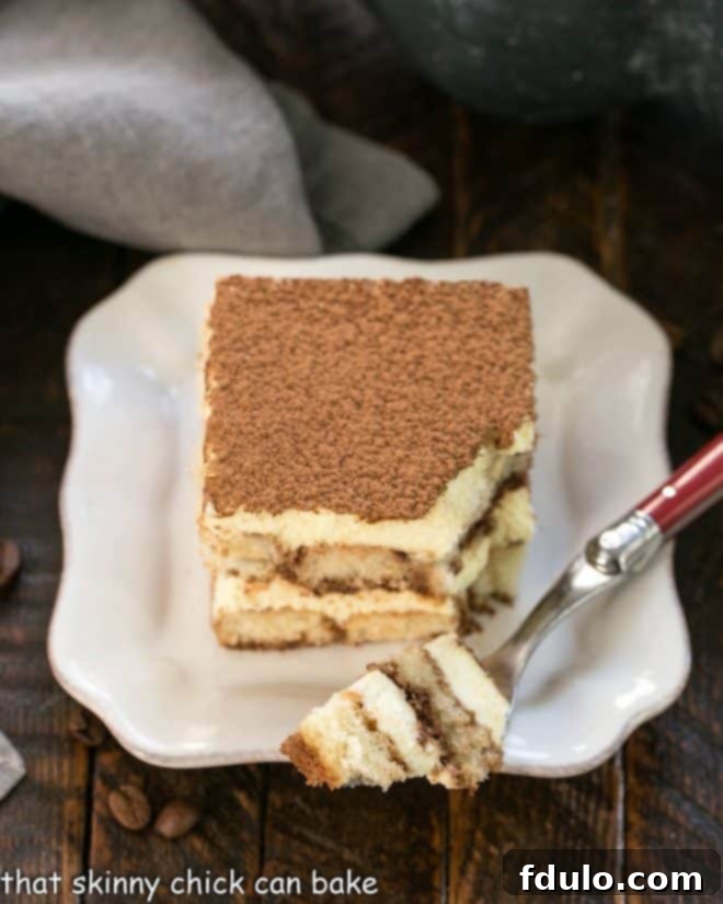 Unlock the Secret to Perfect Tiramisu 3 A slice of tiramisu with a forkful removed