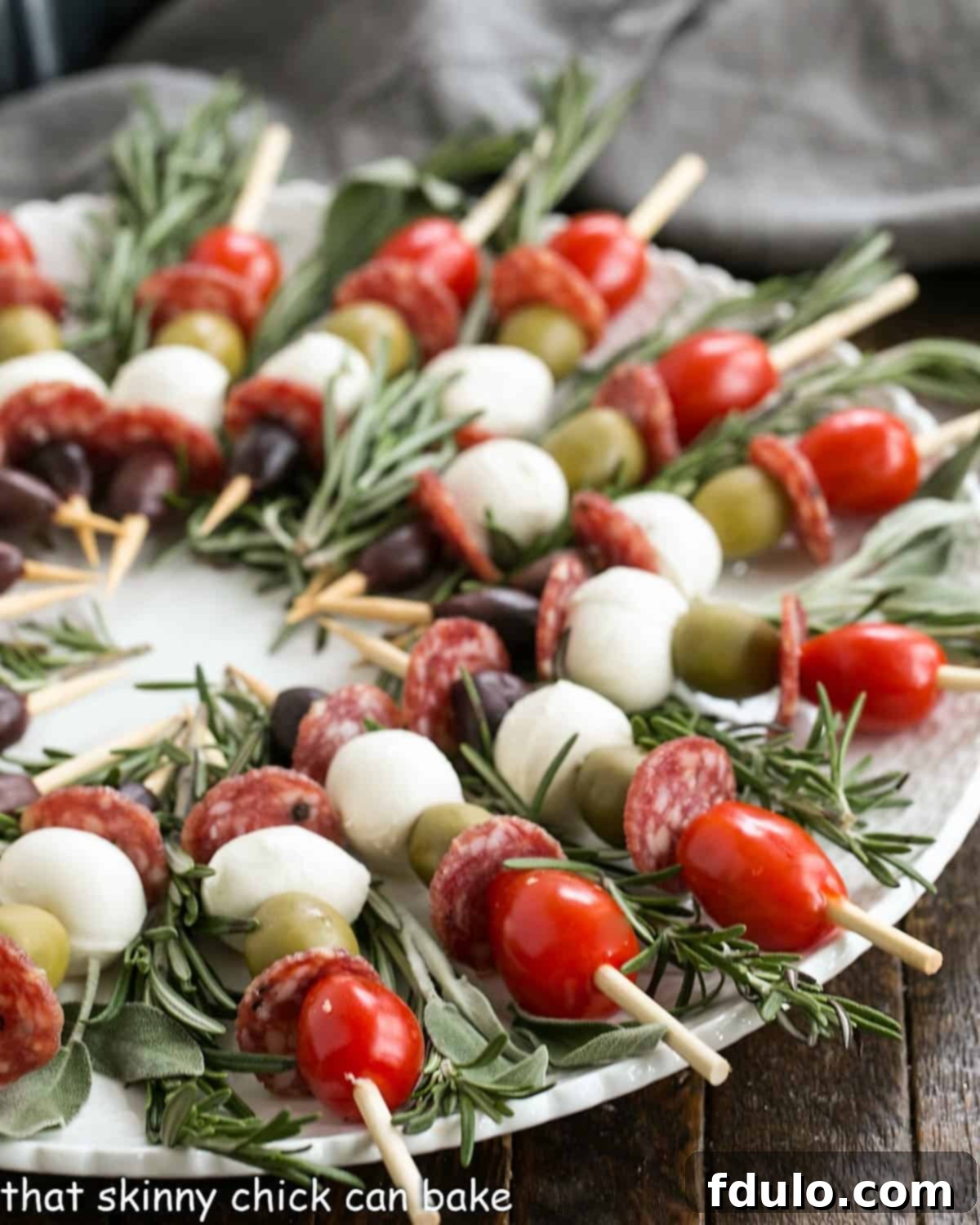 Close view of Appetizer kabobs on a round white plate.