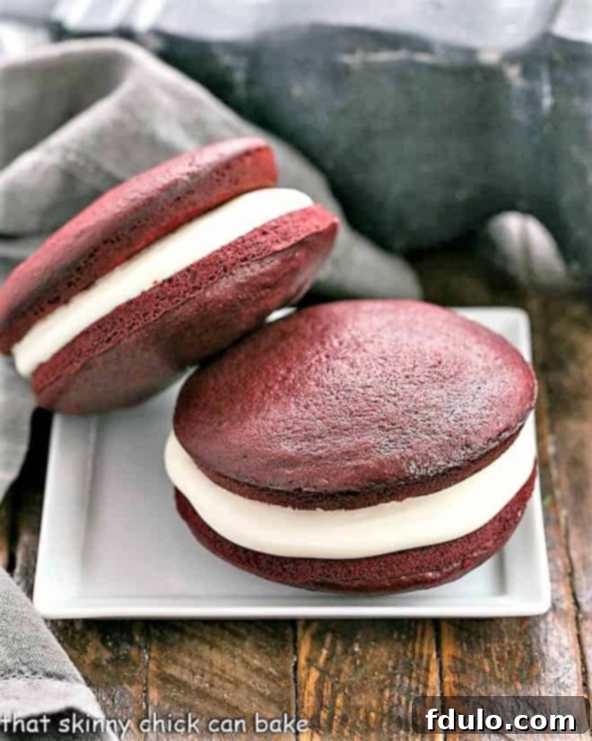 Two whoopie pies stacked on a square white plate