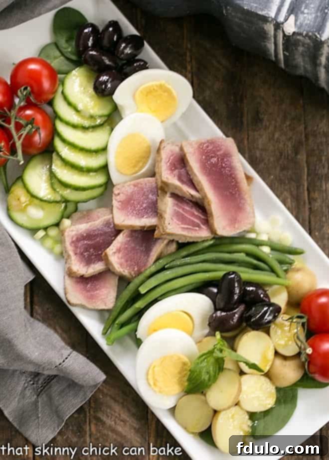 Overhead view of Ahi Tuna Salade Niçoise on a white platter, ready to be served, highlighting the fresh textures.