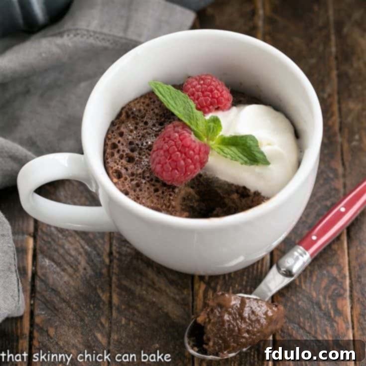 Overhead view of chocolate mug cake with a spoonful removed