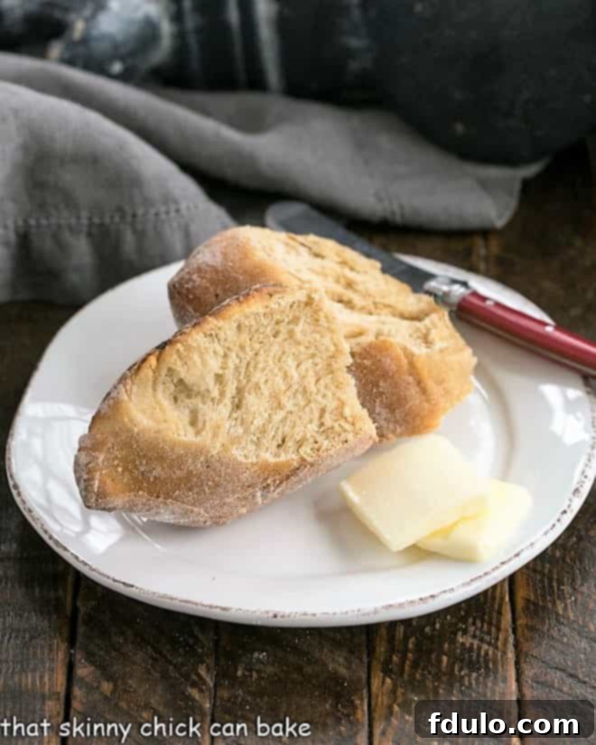 Two slices of Honey Whole Wheat Bread Wreath on a small white plate, invitingly arranged.