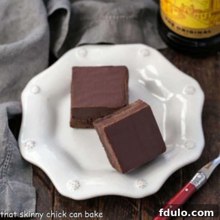 overhead view of 2 kahlua fudge topped brownies on a white ceramic plate