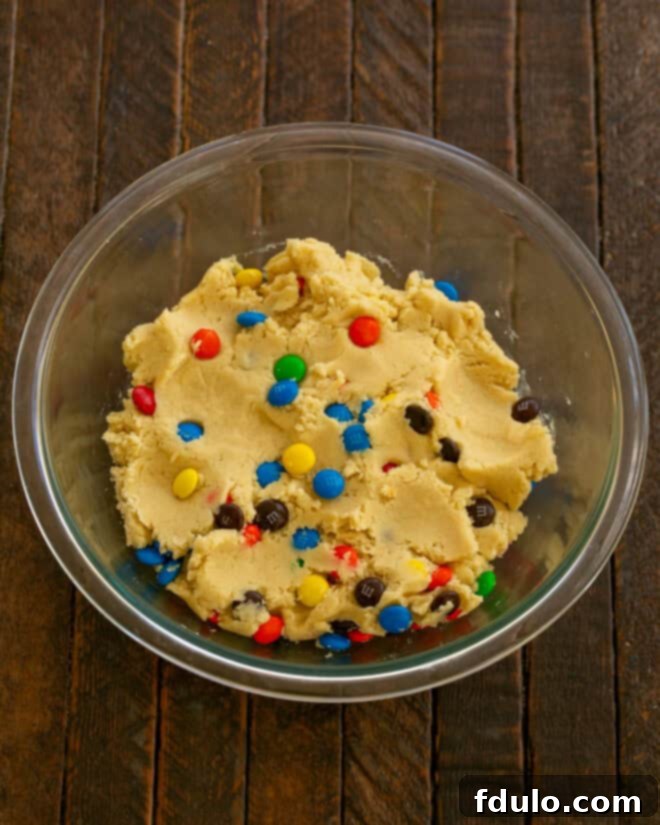 Step 4: Mix in flour, then M&Ms.